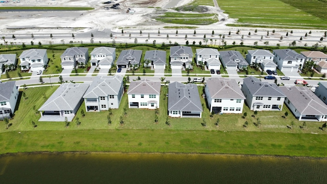 drone / aerial view featuring a water view and a residential view