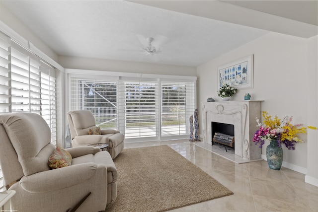 living room with ceiling fan and a premium fireplace