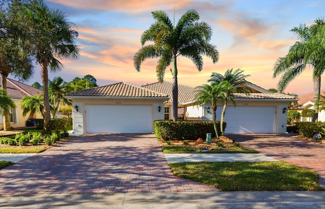 mediterranean / spanish-style home with a garage