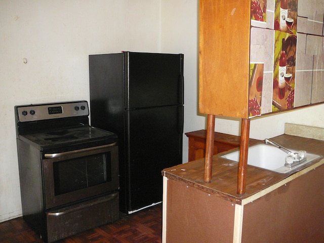 kitchen featuring black refrigerator, sink, electric range, and dark parquet floors