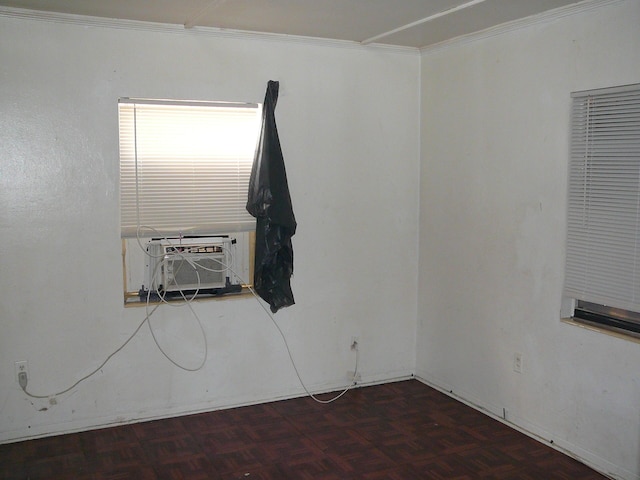 spare room with cooling unit, ornamental molding, and dark parquet floors