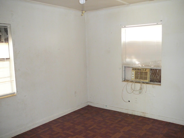 empty room featuring crown molding, cooling unit, and dark parquet floors