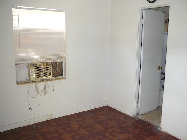 unfurnished room featuring dark parquet flooring and cooling unit