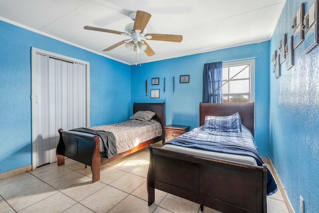 tiled bedroom with ceiling fan and ornamental molding