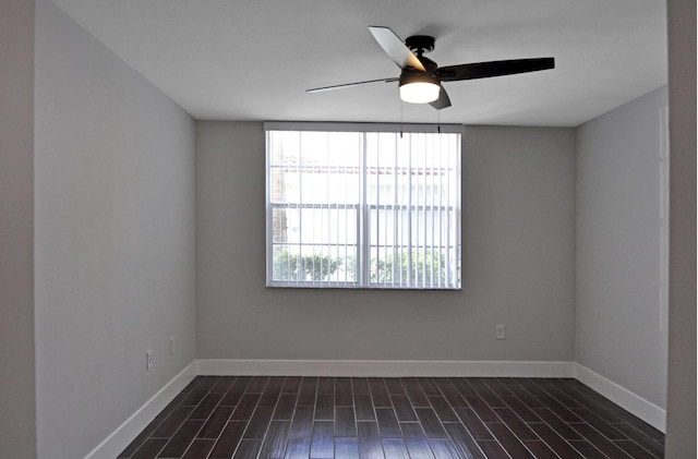 unfurnished room featuring dark wood-type flooring and ceiling fan