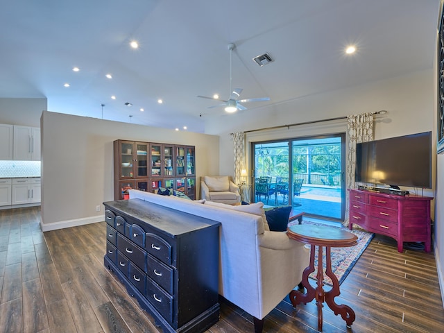 living room with ceiling fan and dark hardwood / wood-style flooring