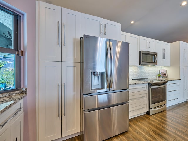 kitchen featuring stone counters, stainless steel appliances, dark hardwood / wood-style flooring, and white cabinets