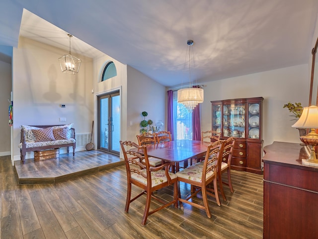 dining room featuring an inviting chandelier, dark hardwood / wood-style flooring, and french doors