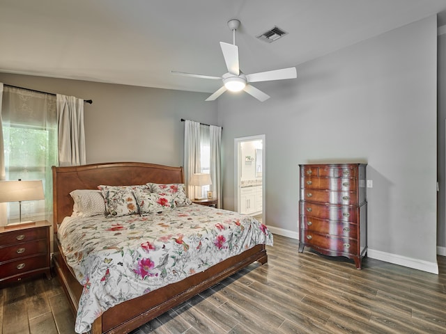 bedroom featuring ceiling fan, lofted ceiling, dark hardwood / wood-style flooring, and ensuite bath