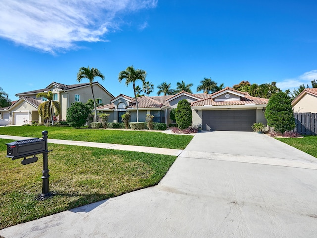 view of front of home with a garage and a front yard