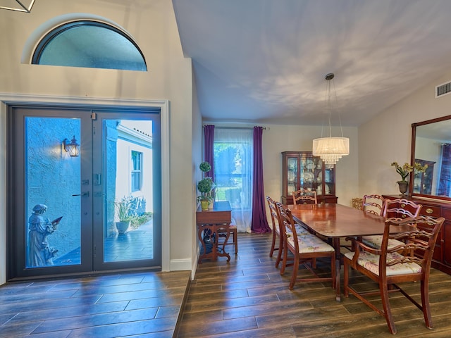 foyer with dark hardwood / wood-style flooring, french doors, and a chandelier