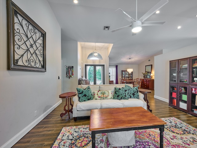 living room with lofted ceiling, dark hardwood / wood-style floors, and ceiling fan