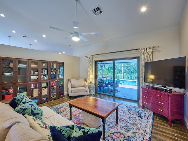 living room with dark hardwood / wood-style floors and ceiling fan