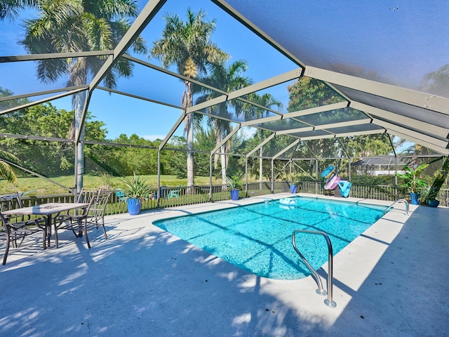 view of swimming pool with a lanai, a patio area, and a playground