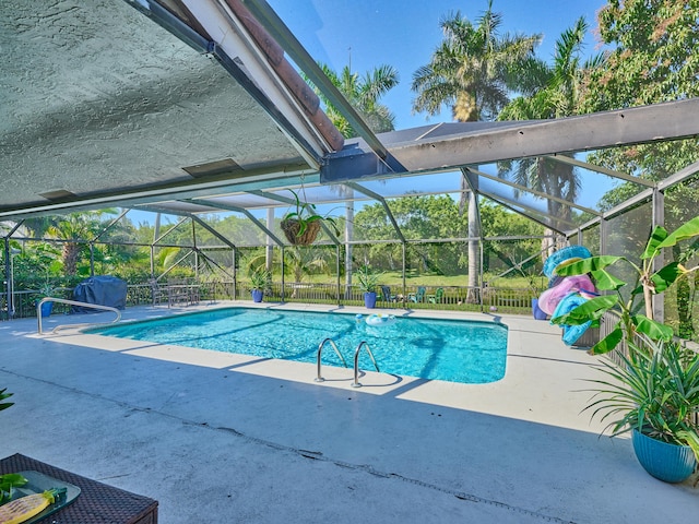 view of pool with a lanai and a patio area