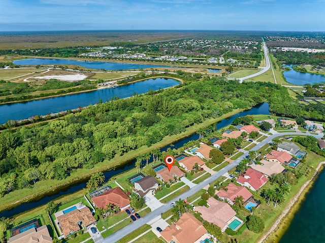 birds eye view of property with a water view