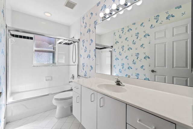 bathroom featuring toilet, shower / bath combination with glass door, visible vents, tile patterned floors, and wallpapered walls