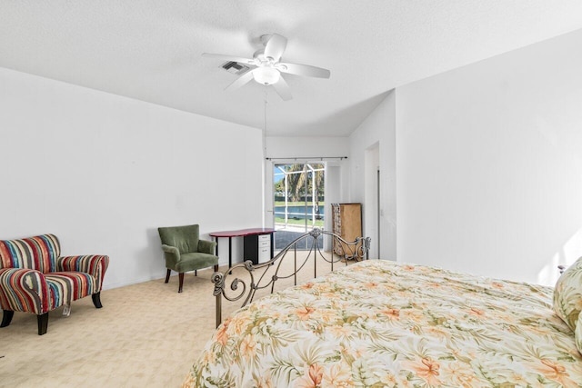 bedroom featuring carpet floors, access to exterior, visible vents, a ceiling fan, and a textured ceiling