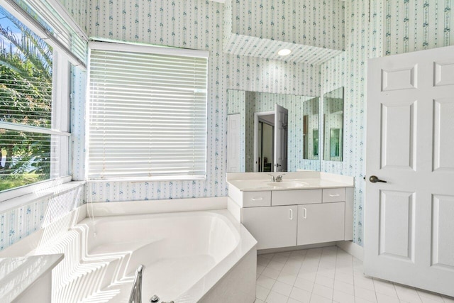 bathroom featuring vanity, tile patterned floors, a bath, and wallpapered walls