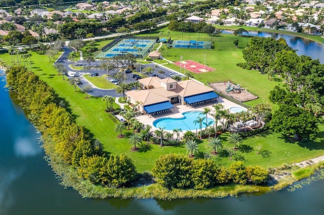 drone / aerial view featuring a residential view and a water view