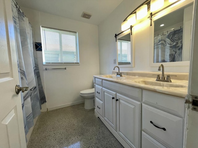 bathroom with vanity, a shower with shower curtain, and toilet