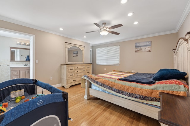 bedroom featuring ensuite bathroom, sink, light wood-type flooring, ornamental molding, and ceiling fan