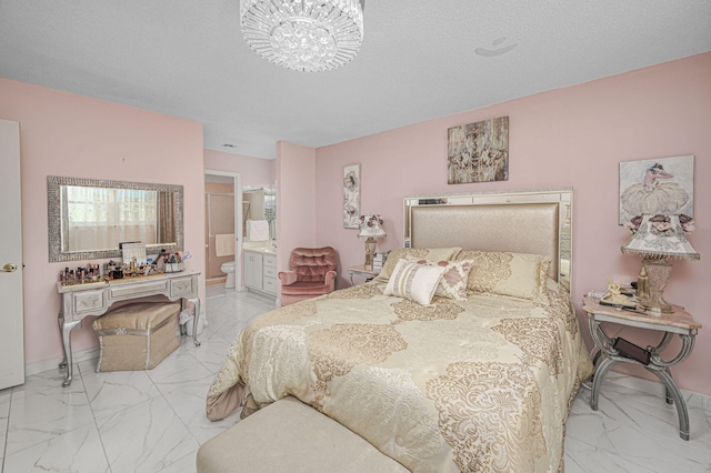 bedroom featuring ensuite bathroom and a textured ceiling