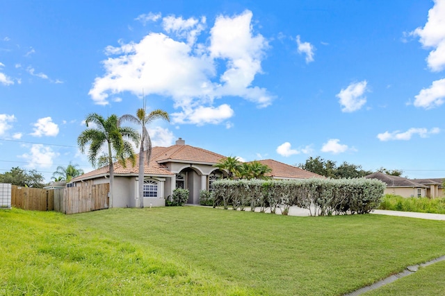 mediterranean / spanish house with a front yard