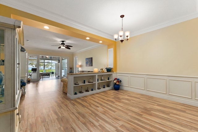 interior space with ceiling fan with notable chandelier, ornamental molding, and light hardwood / wood-style floors