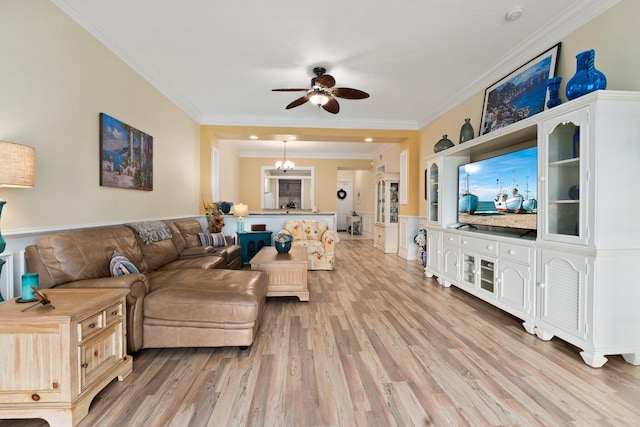 living room with crown molding, light hardwood / wood-style flooring, and ceiling fan with notable chandelier