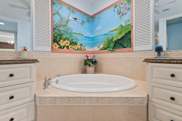 bathroom with vanity, tiled bath, and ceiling fan