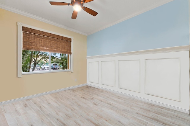 empty room featuring ornamental molding, ceiling fan, and light wood-type flooring