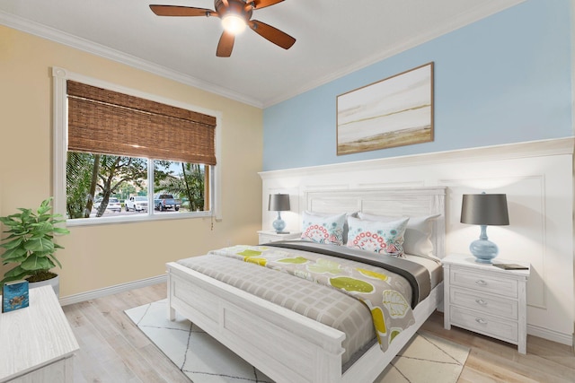 bedroom with crown molding, ceiling fan, and light wood-type flooring