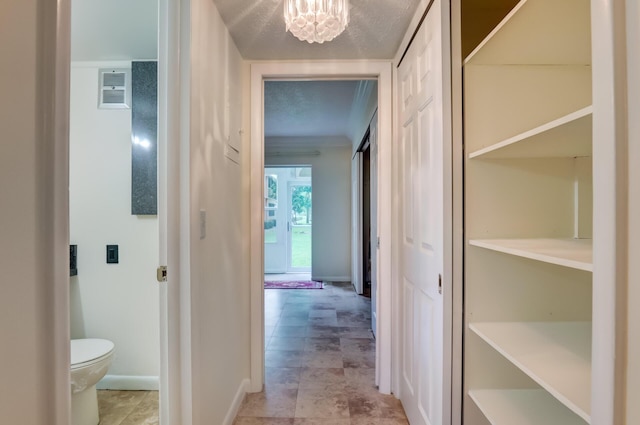 hall with a chandelier and a textured ceiling