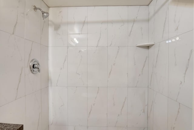 bathroom with a tile shower