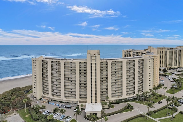 bird's eye view featuring a water view and a view of the beach