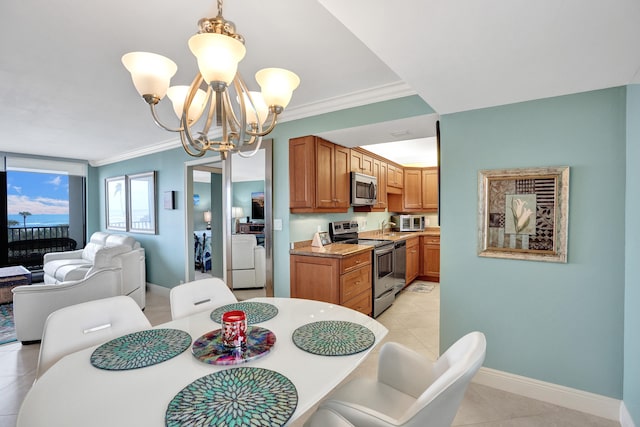 tiled dining space with crown molding, an inviting chandelier, and washing machine and dryer