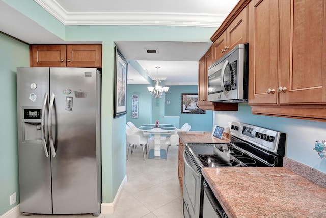 kitchen with pendant lighting, light tile patterned floors, stainless steel appliances, ornamental molding, and a chandelier