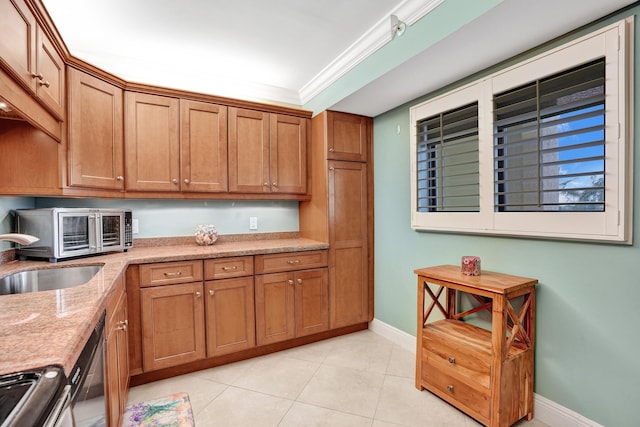 kitchen featuring light tile patterned flooring, sink, light stone counters, ornamental molding, and stainless steel appliances