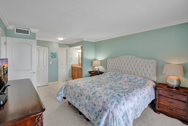 bedroom with crown molding, ensuite bathroom, light carpet, and a closet