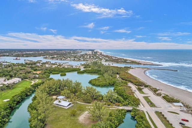 drone / aerial view featuring a water view and a view of the beach