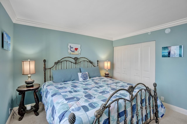 carpeted bedroom with crown molding and a closet