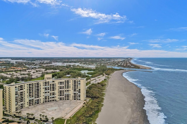 drone / aerial view featuring a water view and a view of the beach