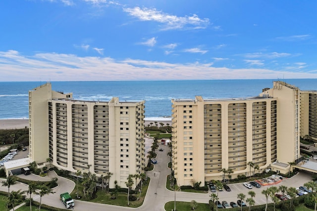 drone / aerial view with a water view and a view of the beach