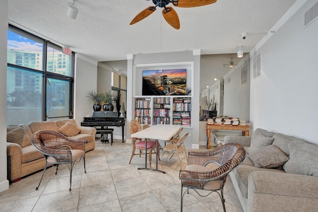 living room featuring floor to ceiling windows, ceiling fan, and a textured ceiling