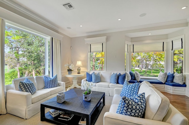 living room featuring ornamental molding and wood-type flooring