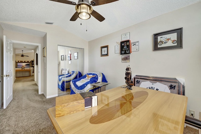 dining area with light carpet, ceiling fan, lofted ceiling, and a textured ceiling