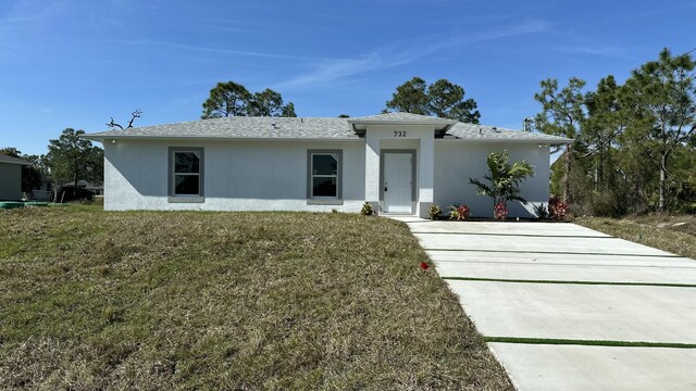 ranch-style house with a front lawn