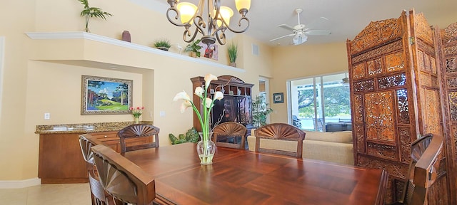 tiled dining room featuring ceiling fan with notable chandelier