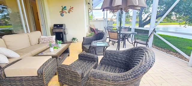 sunroom / solarium featuring a water view